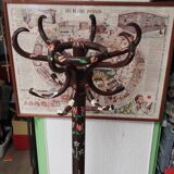 Wooden parrot coat rack with painted floral decoration.