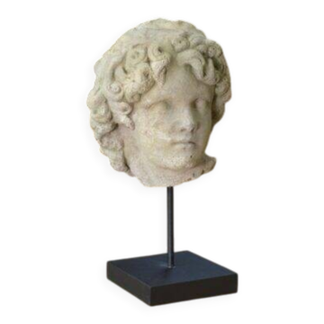 Sculpture of a head in reconstituted stone carved in the antique style of the 19th century