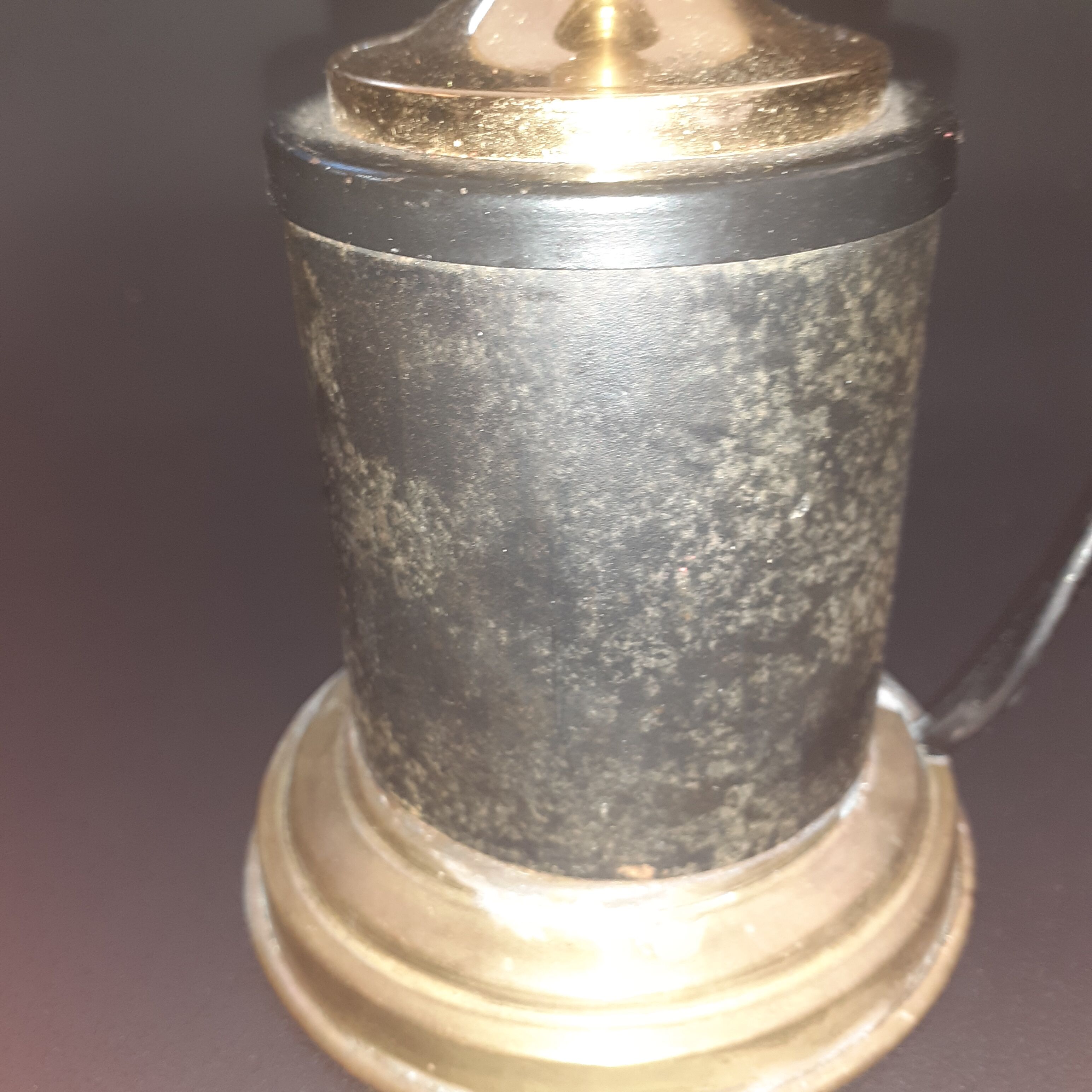 Antique lamp in black and gold metal with its lampshade
