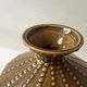 Pyriform vase in glazed ochre ceramic and beads.