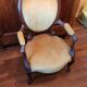 Antique cabriolet armchair in Louis Philippe medallion style.
