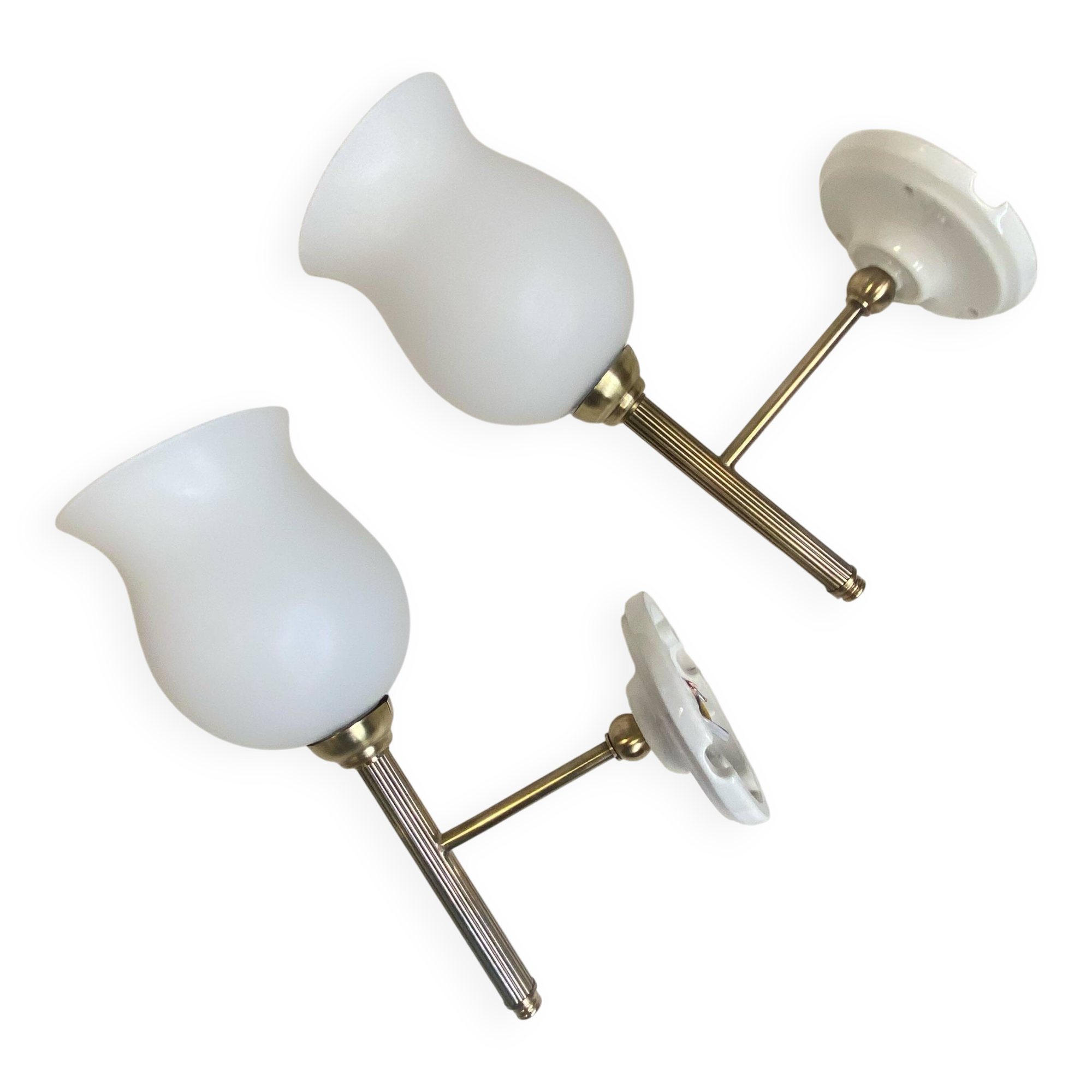 Pair of brass torch wall lights with white opal glass and porcelain