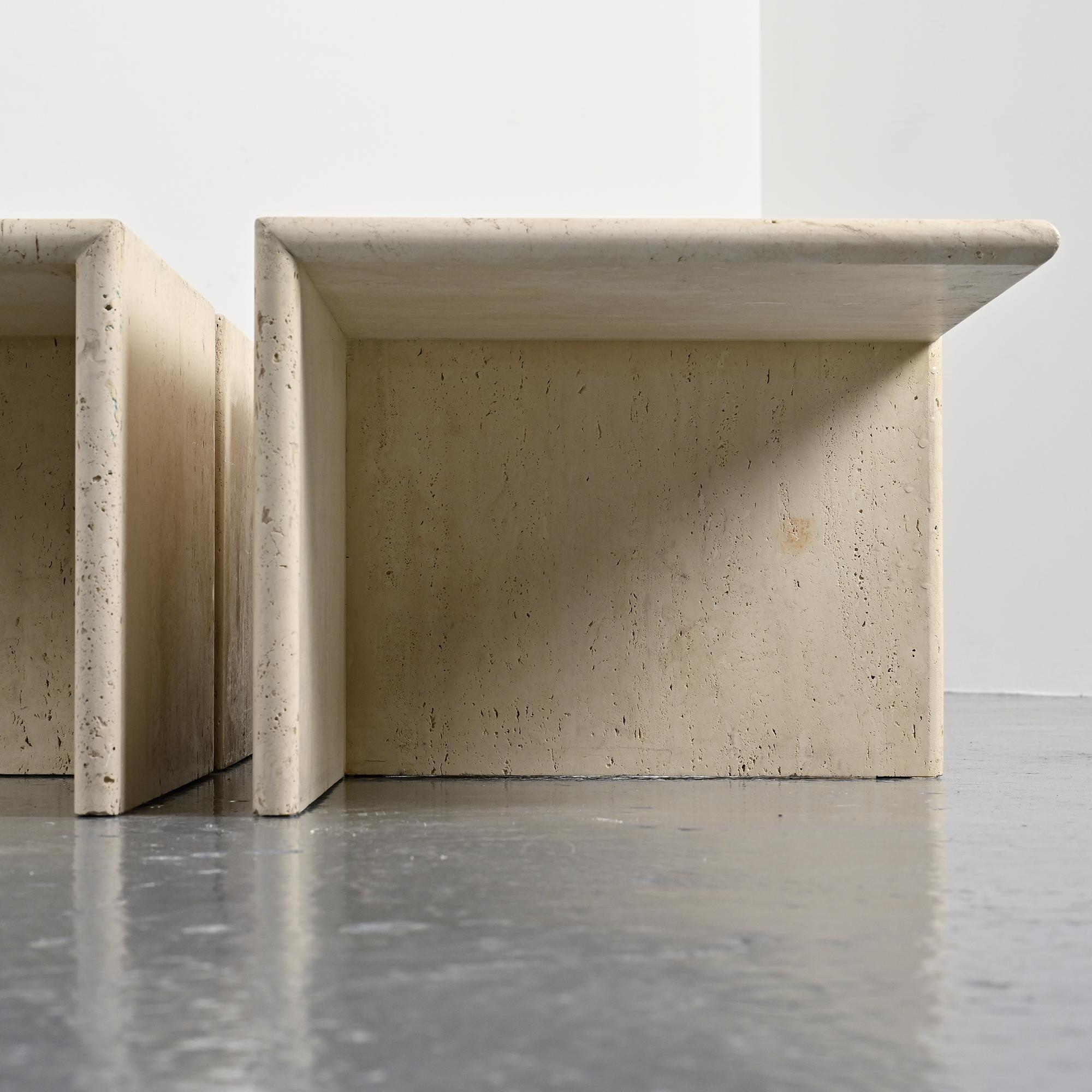 Set of four side tables in travertine, Italy, 1970s.