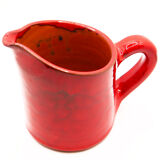 Bright red ceramic pitcher