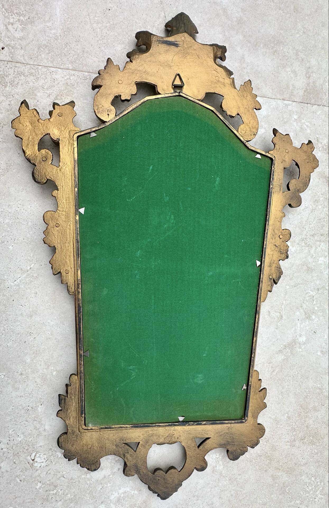 Carved and gilded wooden wall mirror.