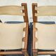 Pair of elm and leather chairs by Maison Regain