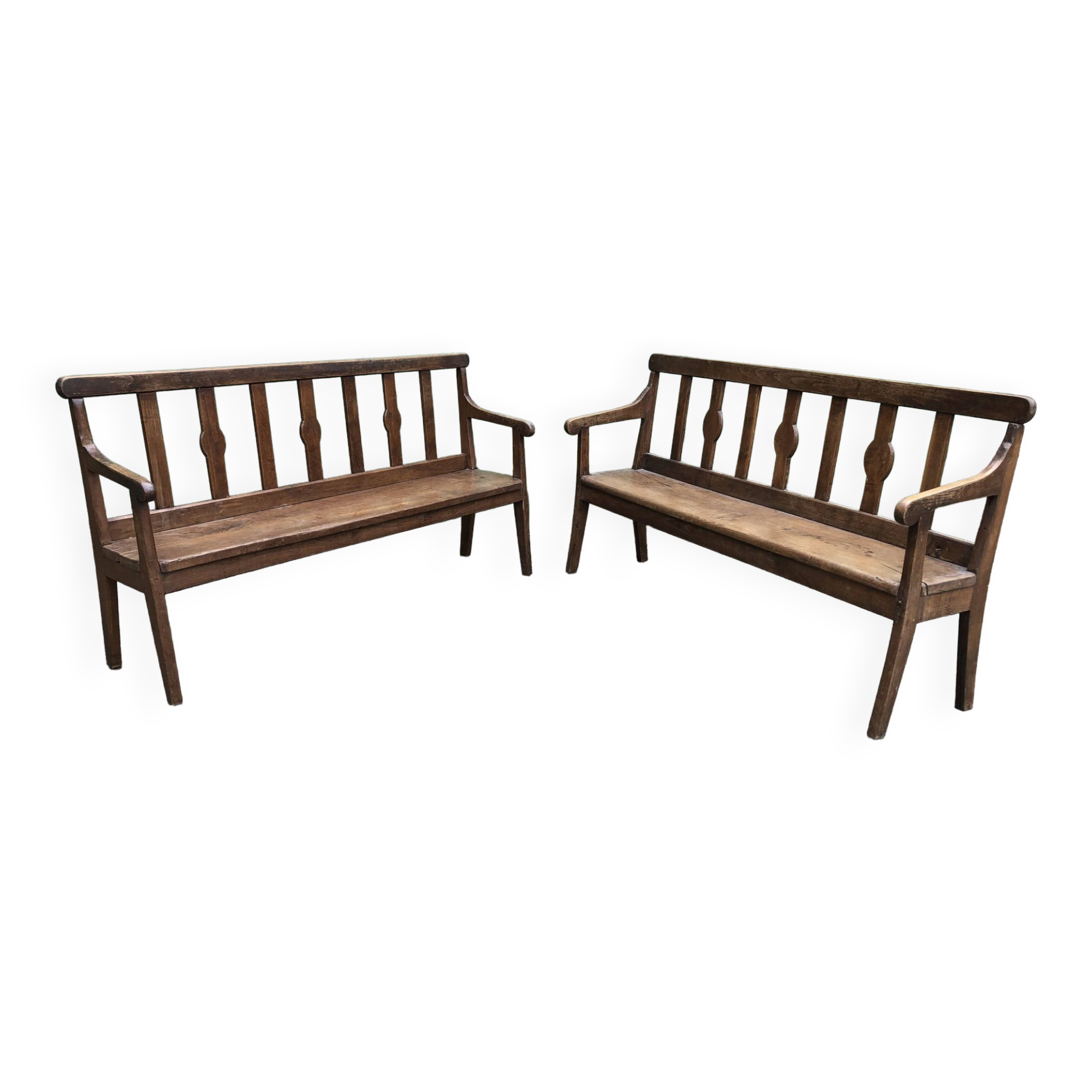 Duo of old solid oak benches with backs and armrests.