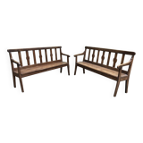 Duo of old solid oak benches with backs and armrests.