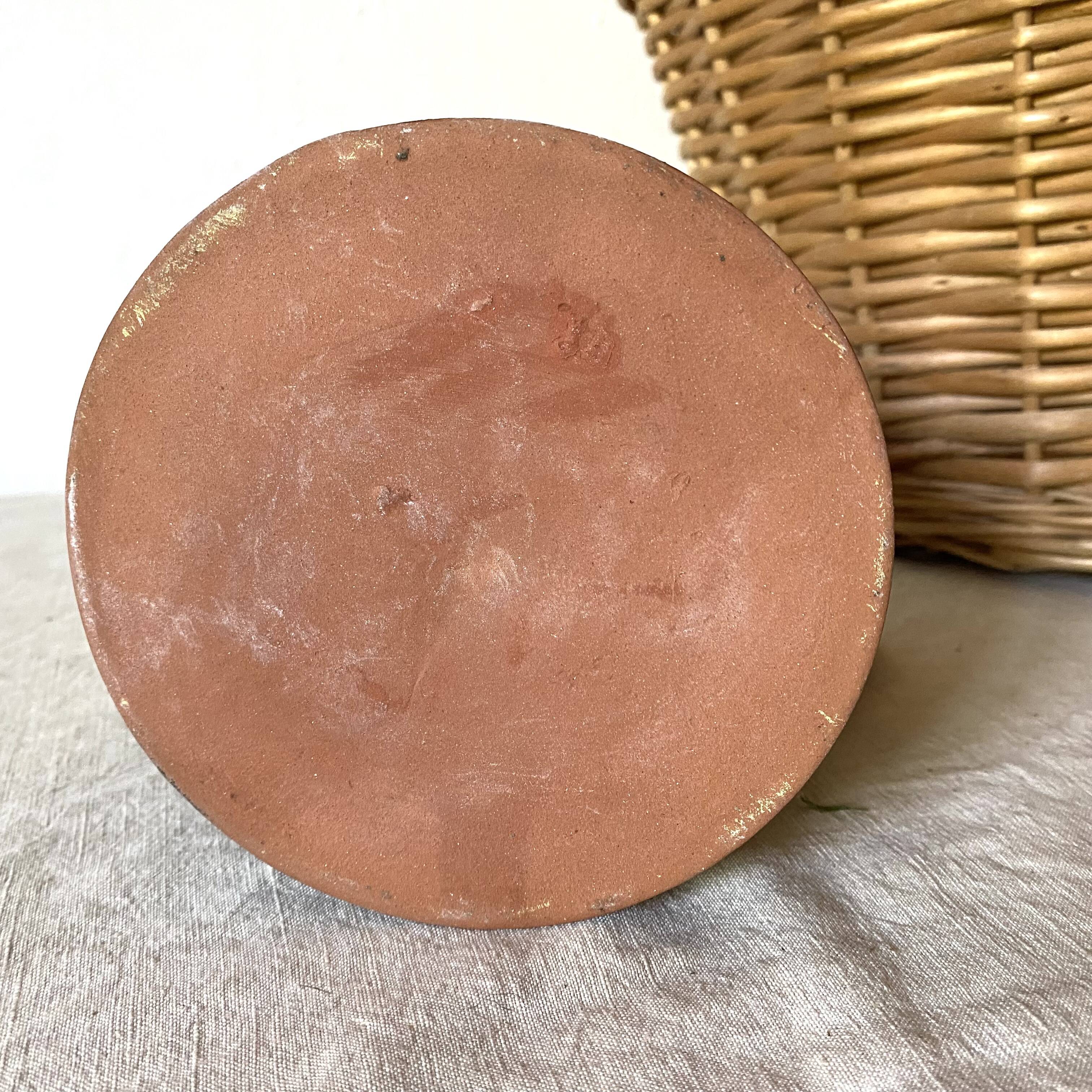 Terracotta pitcher with hand-painted bird decor