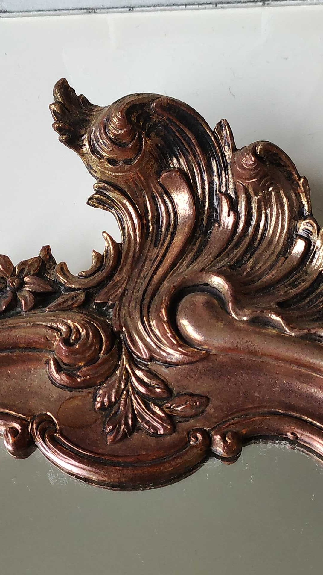 Pretty Baroque style mirror / Louis XV patinated with pink / golden copper reflections. Volutes, leafy shells