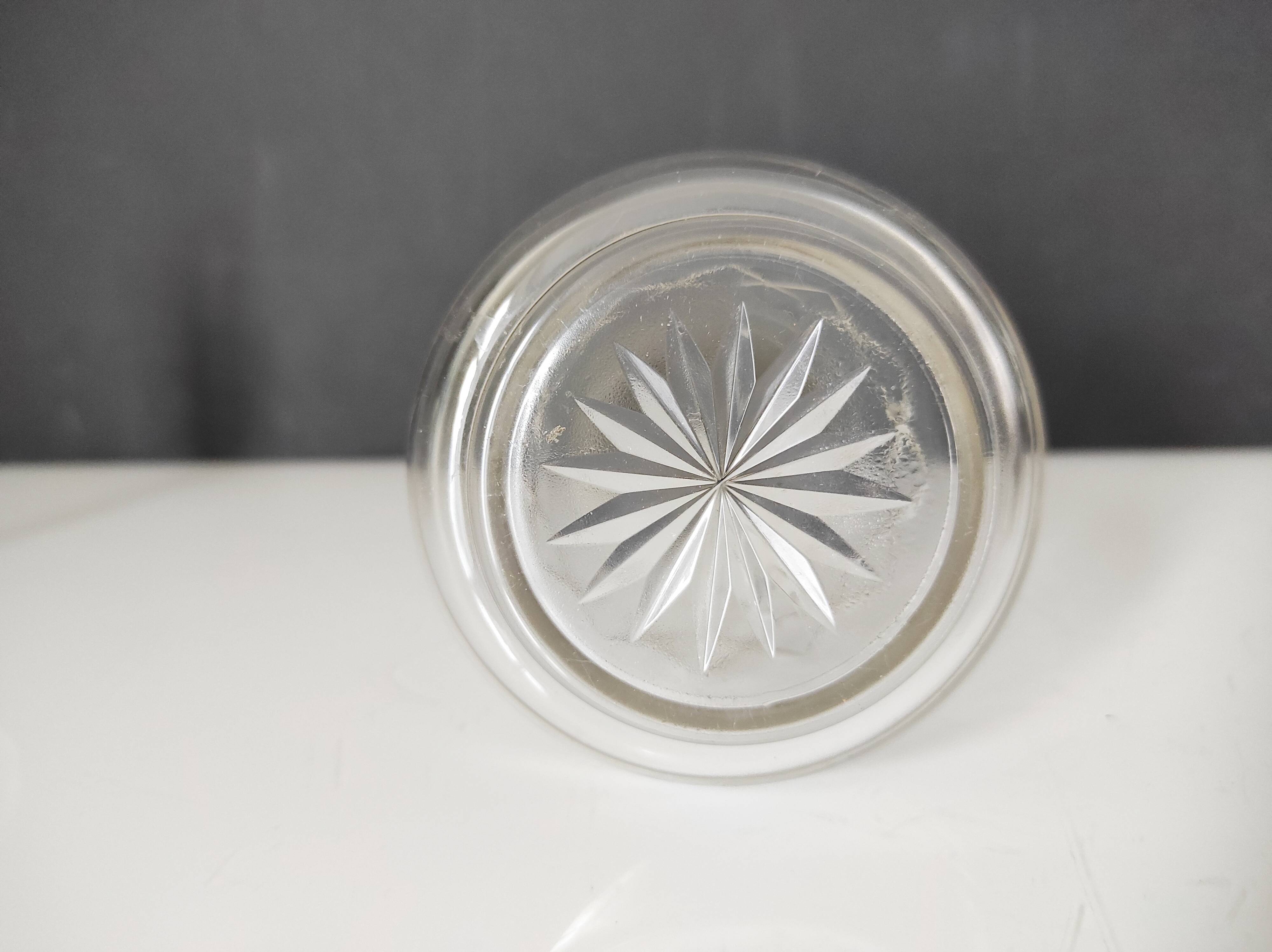 Crystal bottle with silver metal neck rim