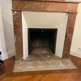 Marble fireplace surround with closed hearth frame.