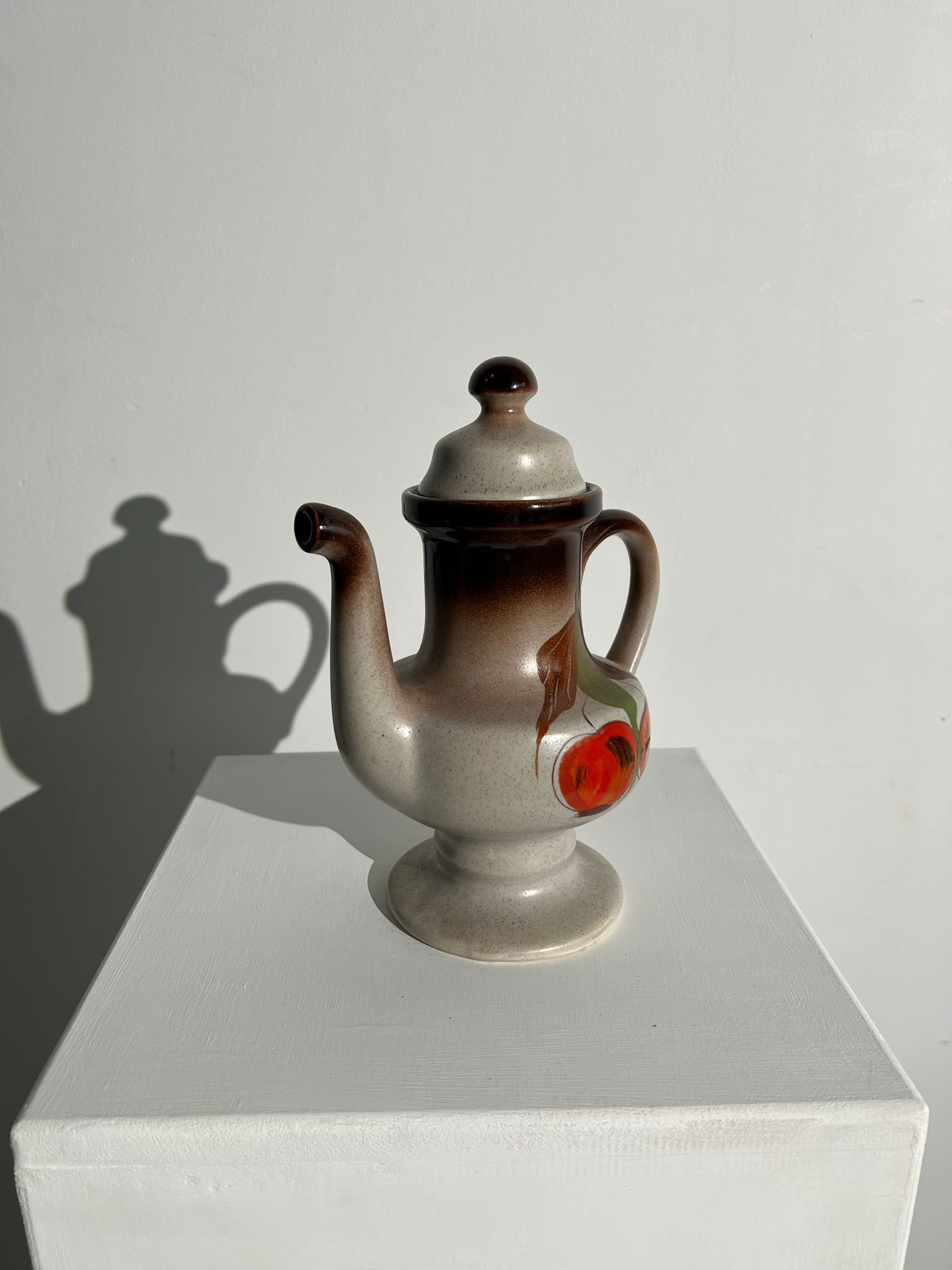 Vintage stoneware teapot with flower and fruit patterns