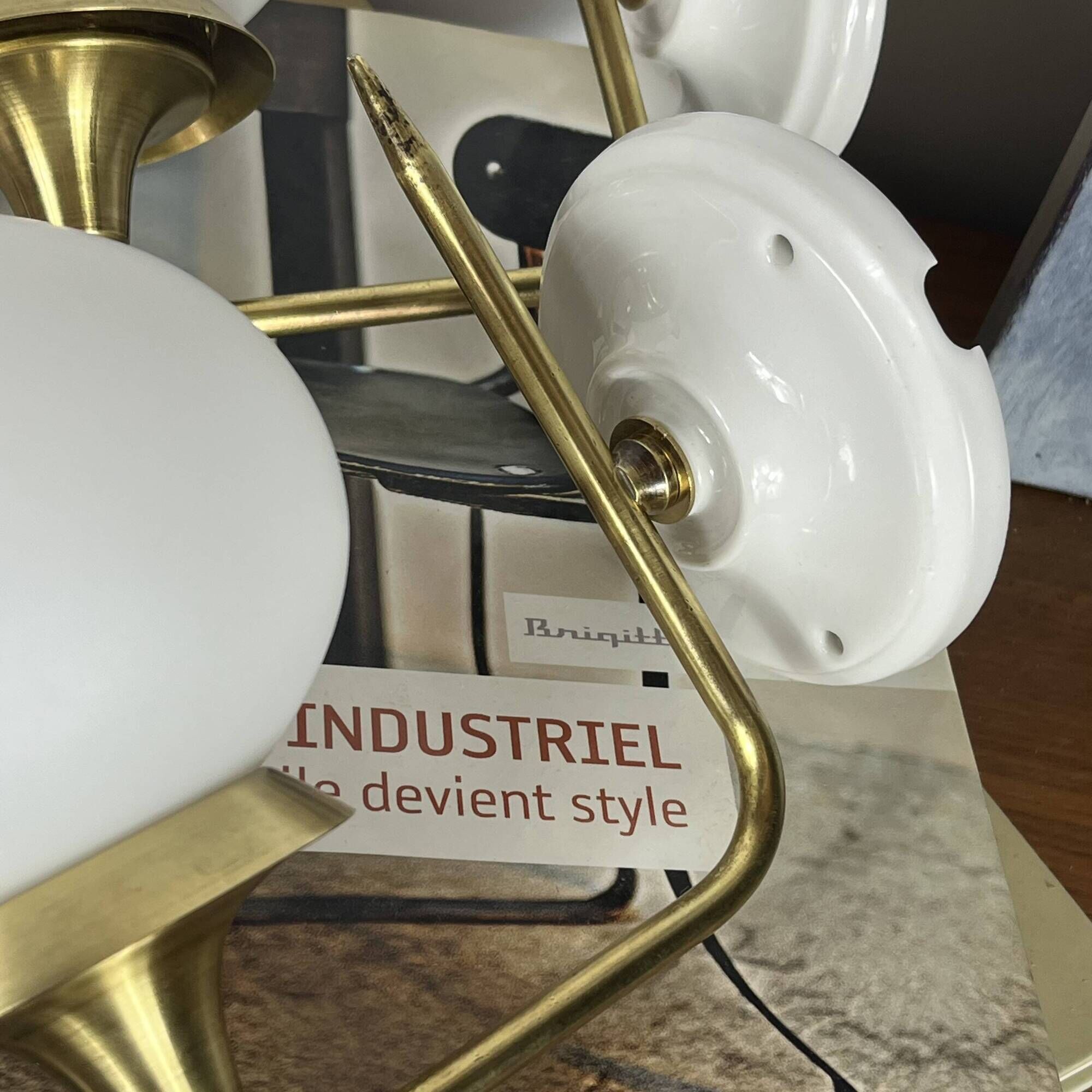 Pair of vintage wall sconces in brass with white glass globe shades.