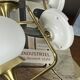 Pair of vintage wall sconces in brass with white glass globe shades.