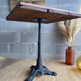 Bistro table with central cast iron leg and rustic top