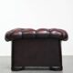 Classic cowhide chesterfield buttonseat armchair in a beautiful red colour and elegant round shapes
