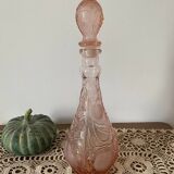 Pink glass carafe with frosted and embossed fruit patterns.