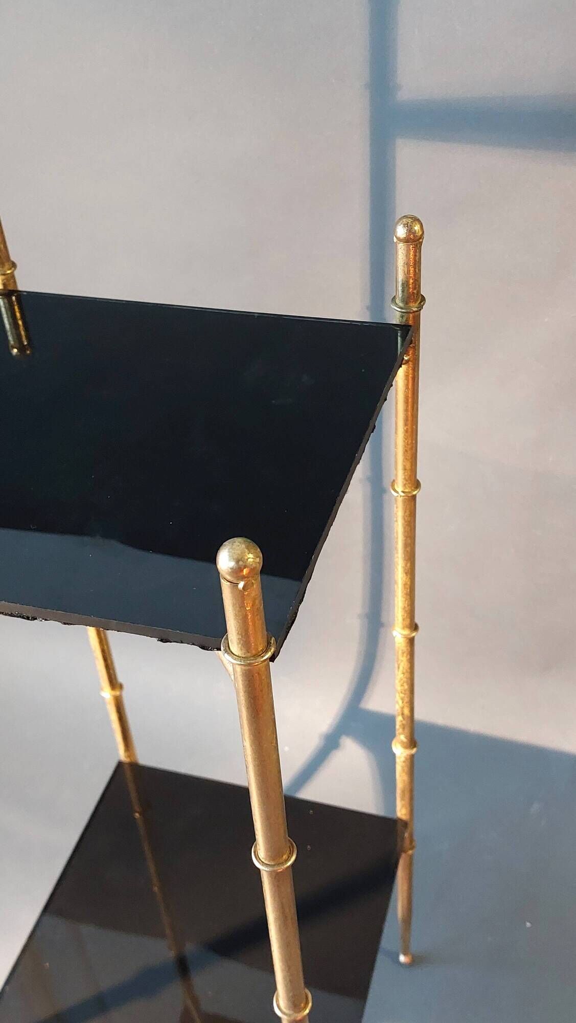 Pedestal table in patinated gilded brass faux foldable bamboo.