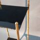 Pedestal table in patinated gilded brass faux foldable bamboo.