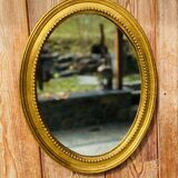 Antique gilded oval mirror
