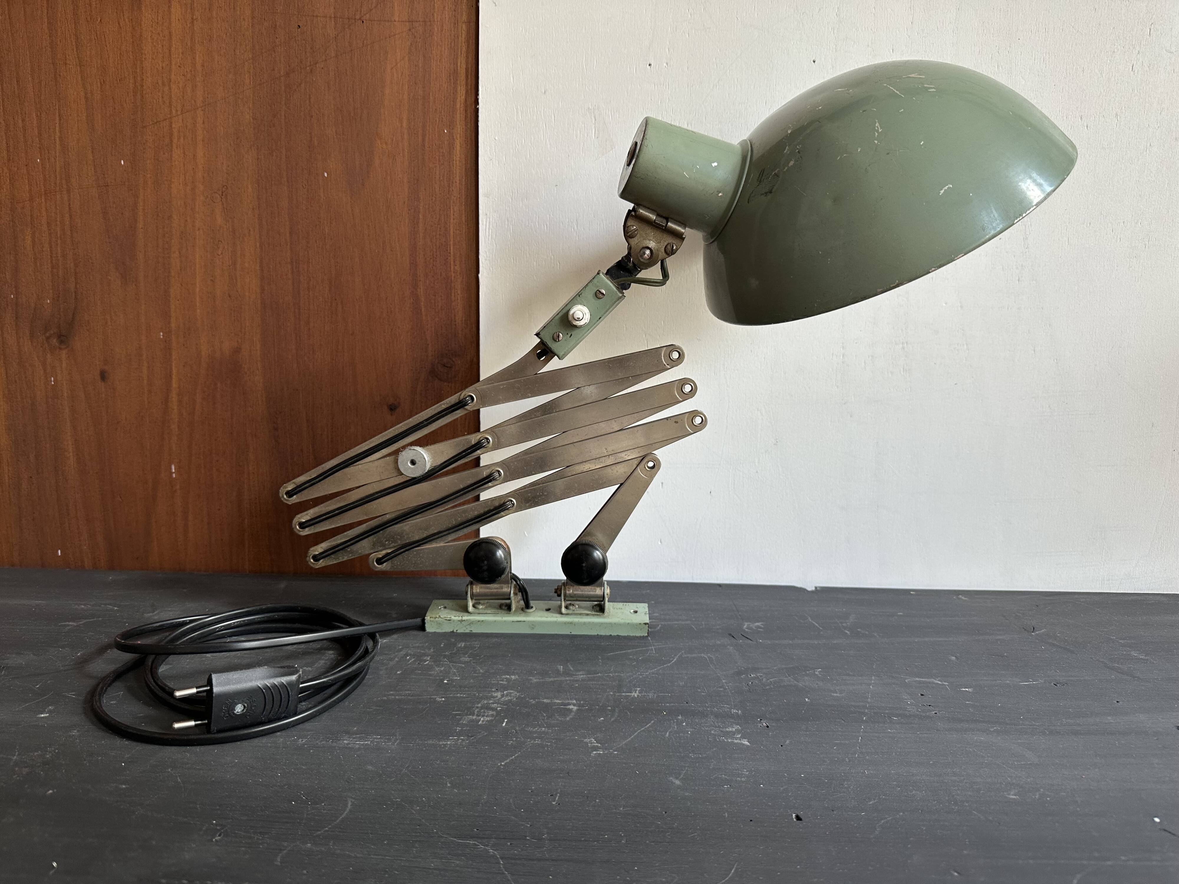 Old extendable accordion lamp in celadon green, workshop spirit.