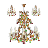 Lustrous chandelier with two wall lights decorated with foliage and pendants.