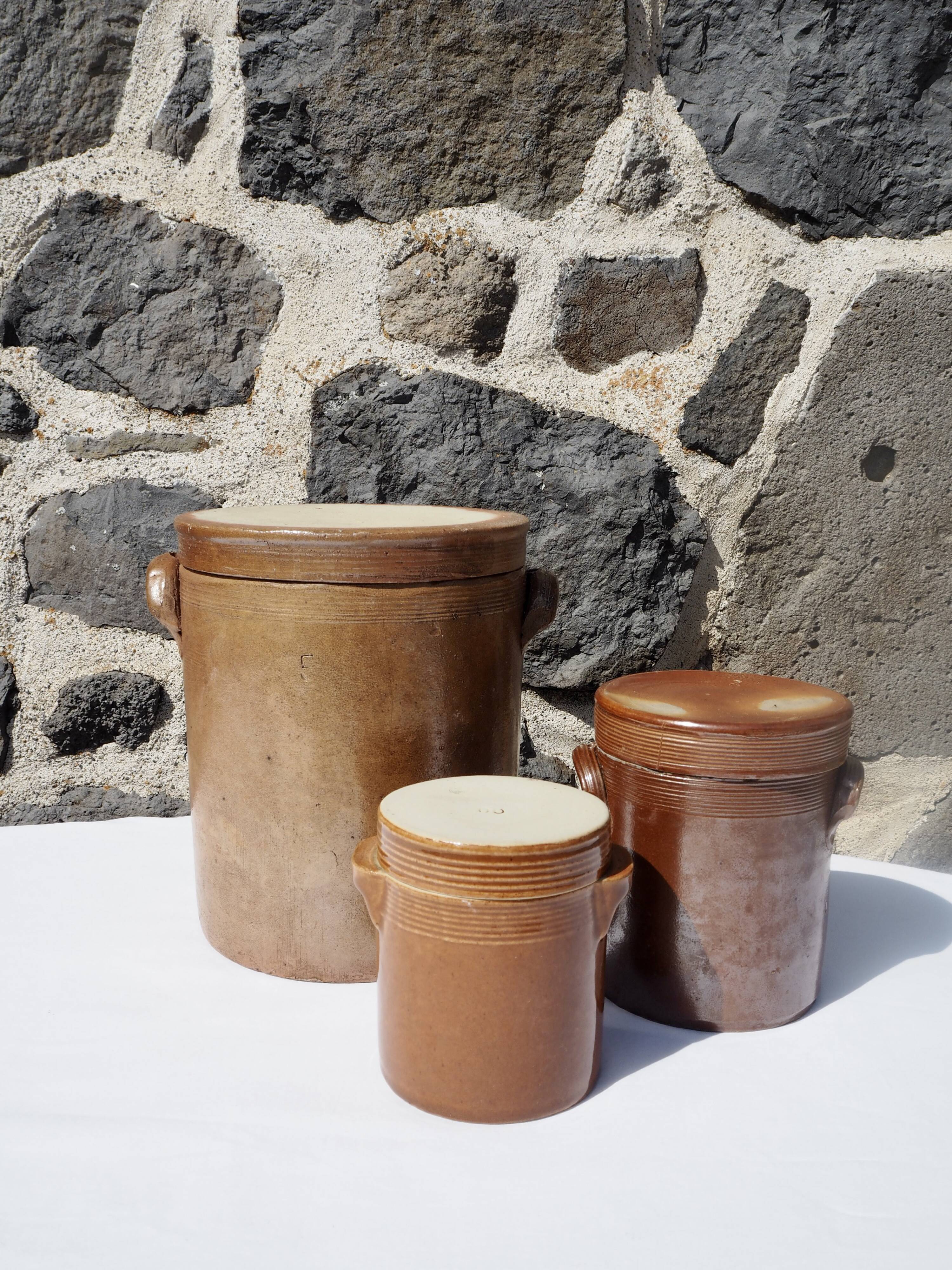 Trio of stoneware pots with lids