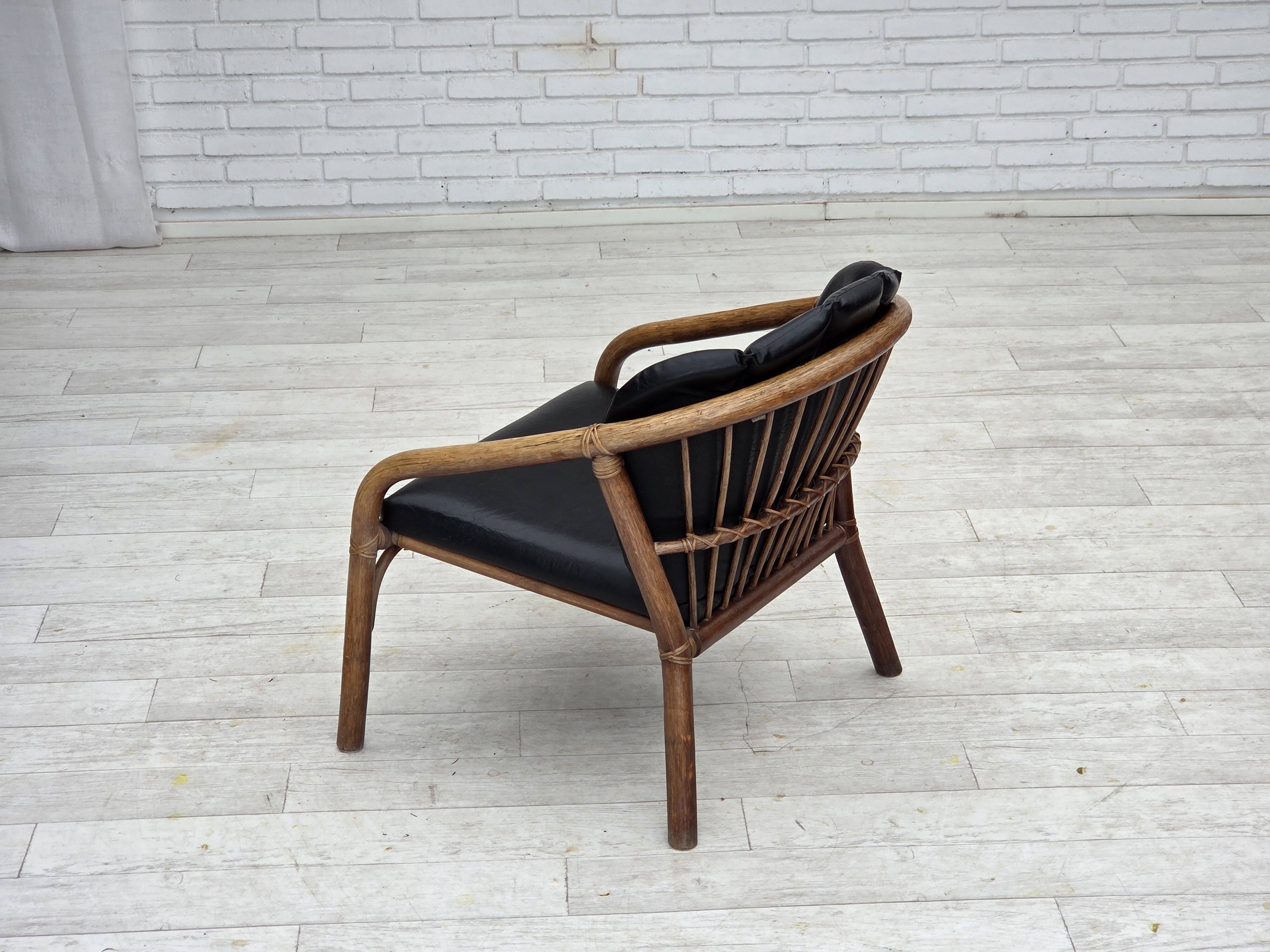 1970s, Danish armchair, rattan, black artificial leather.