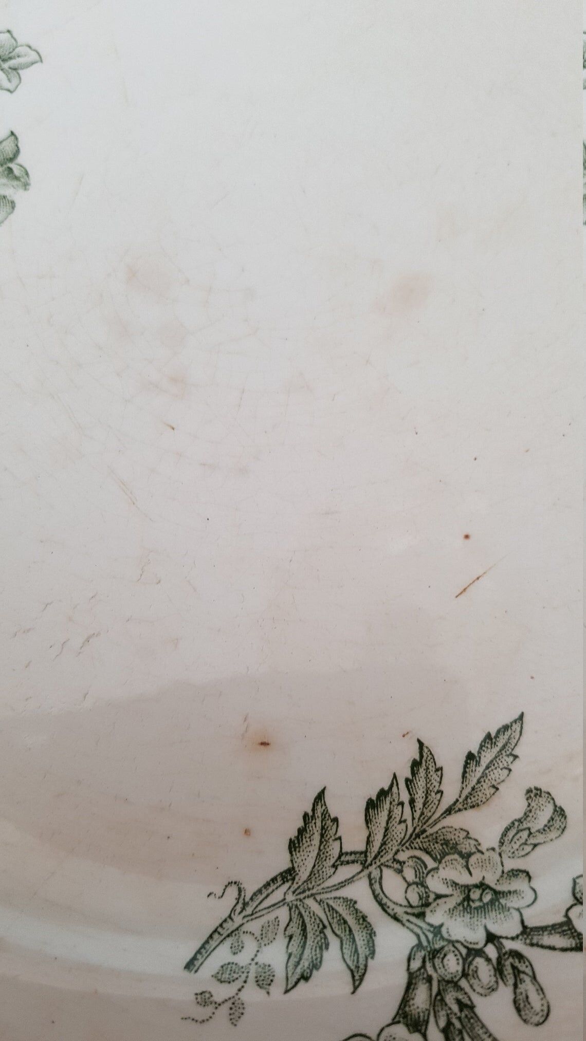 White and green ceramic dish decorated with flowers and butterflies