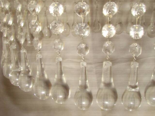 circular chandelier with a brass frame and crystal drops