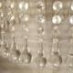 circular chandelier with a brass frame and crystal drops