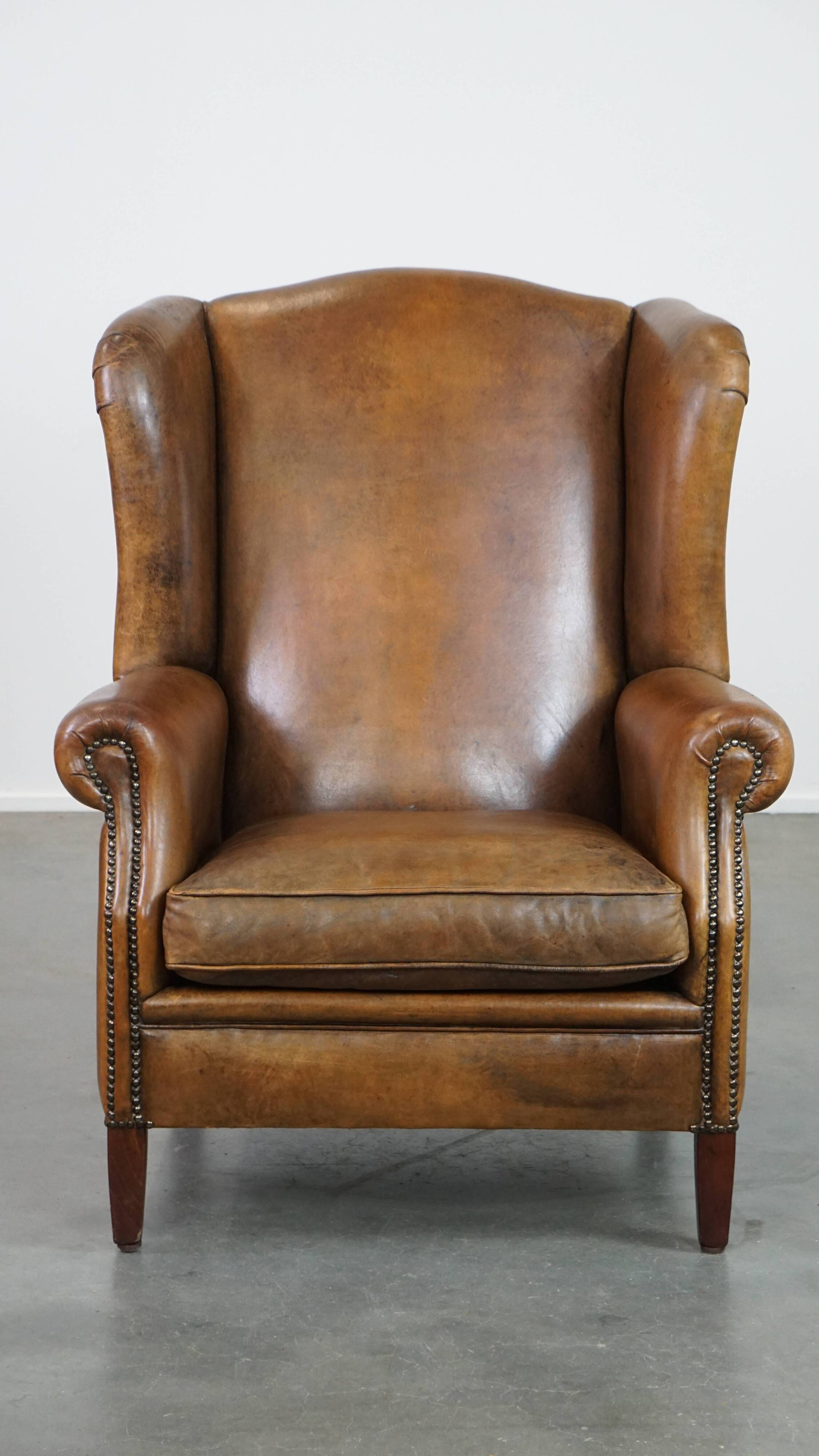 Sheepskin wing chair + XXL patinated footrest