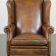 Sheepskin wing chair + XXL patinated footrest