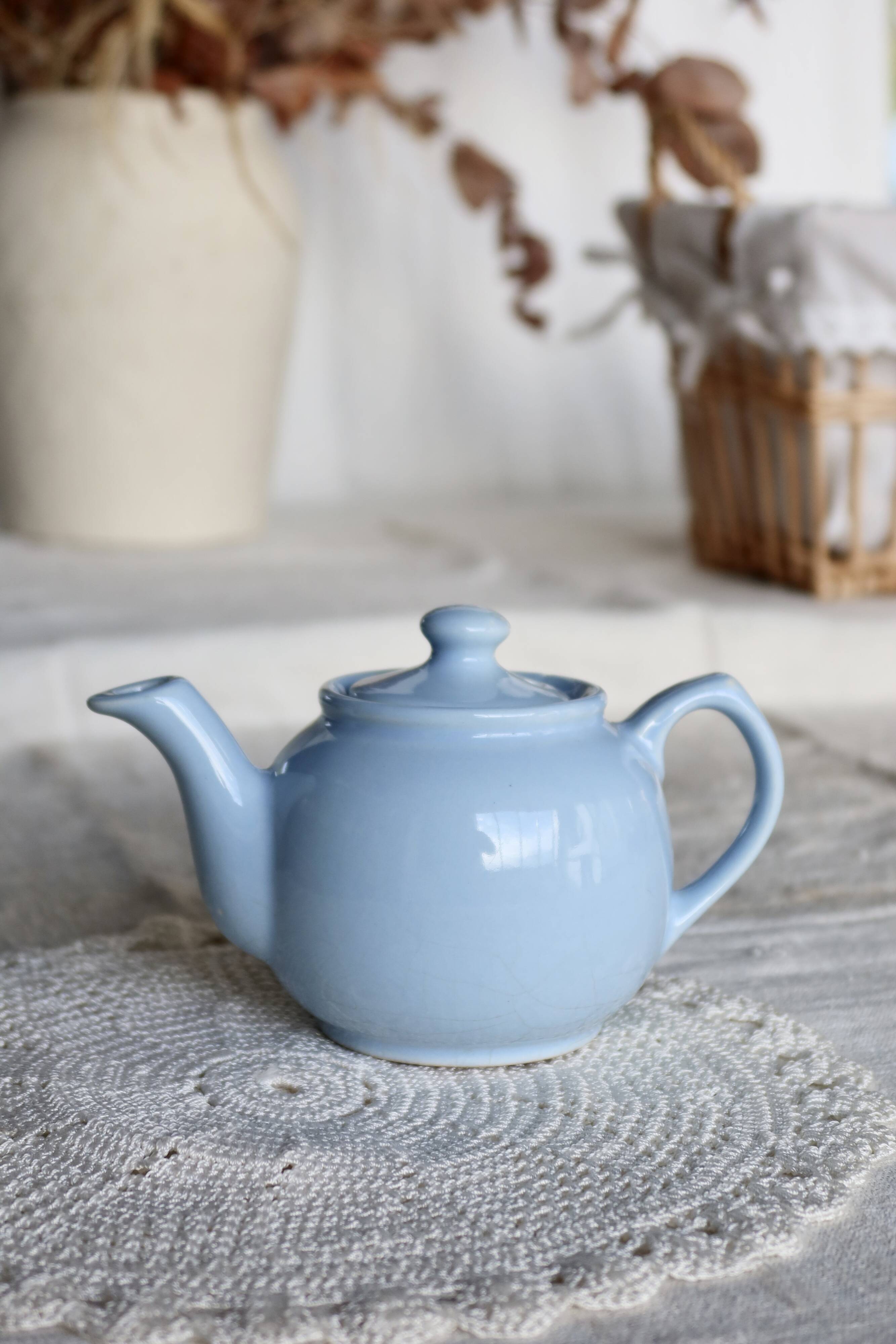 Small vintage sky-blue earthenware teapot