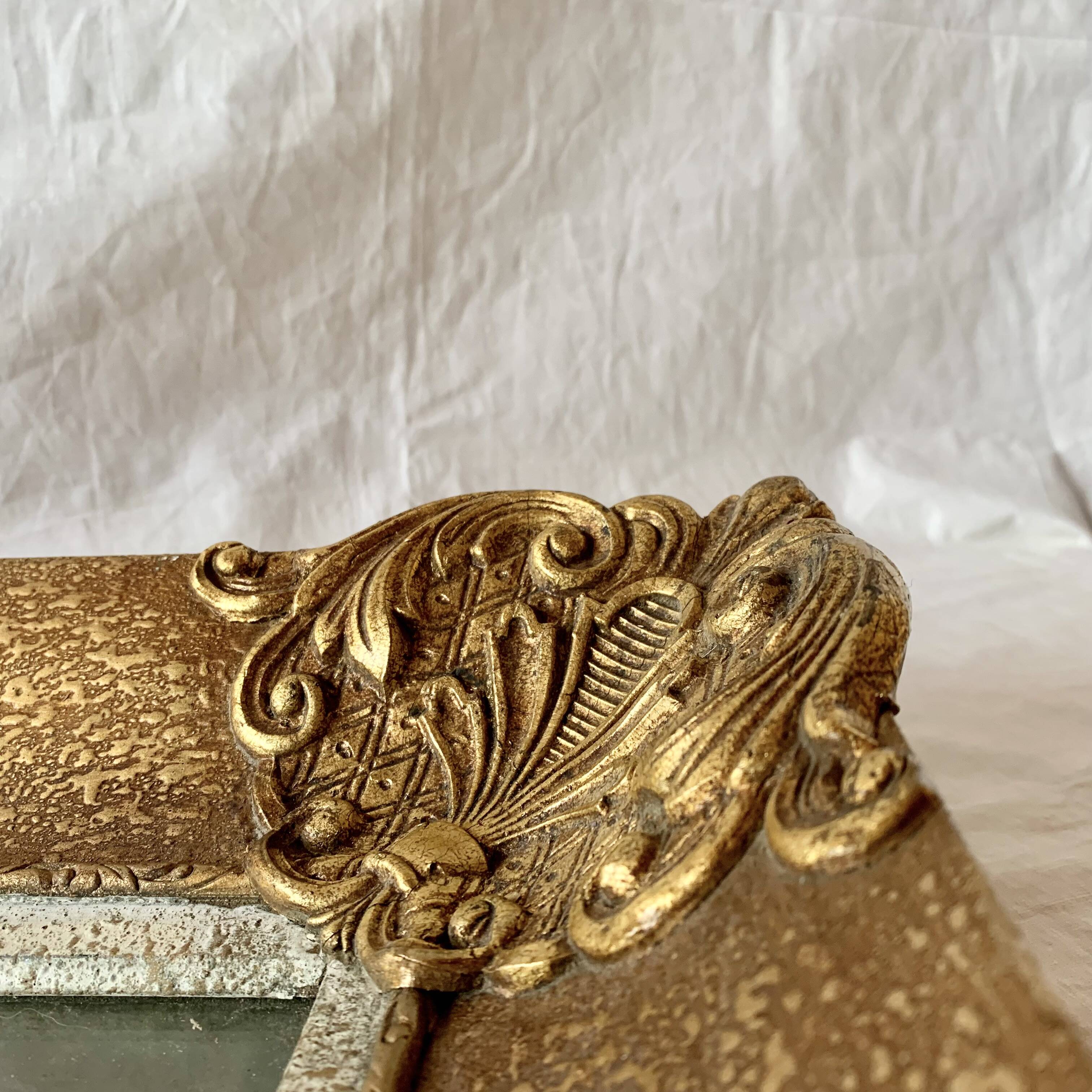 Old wall frame in carved gilded wood