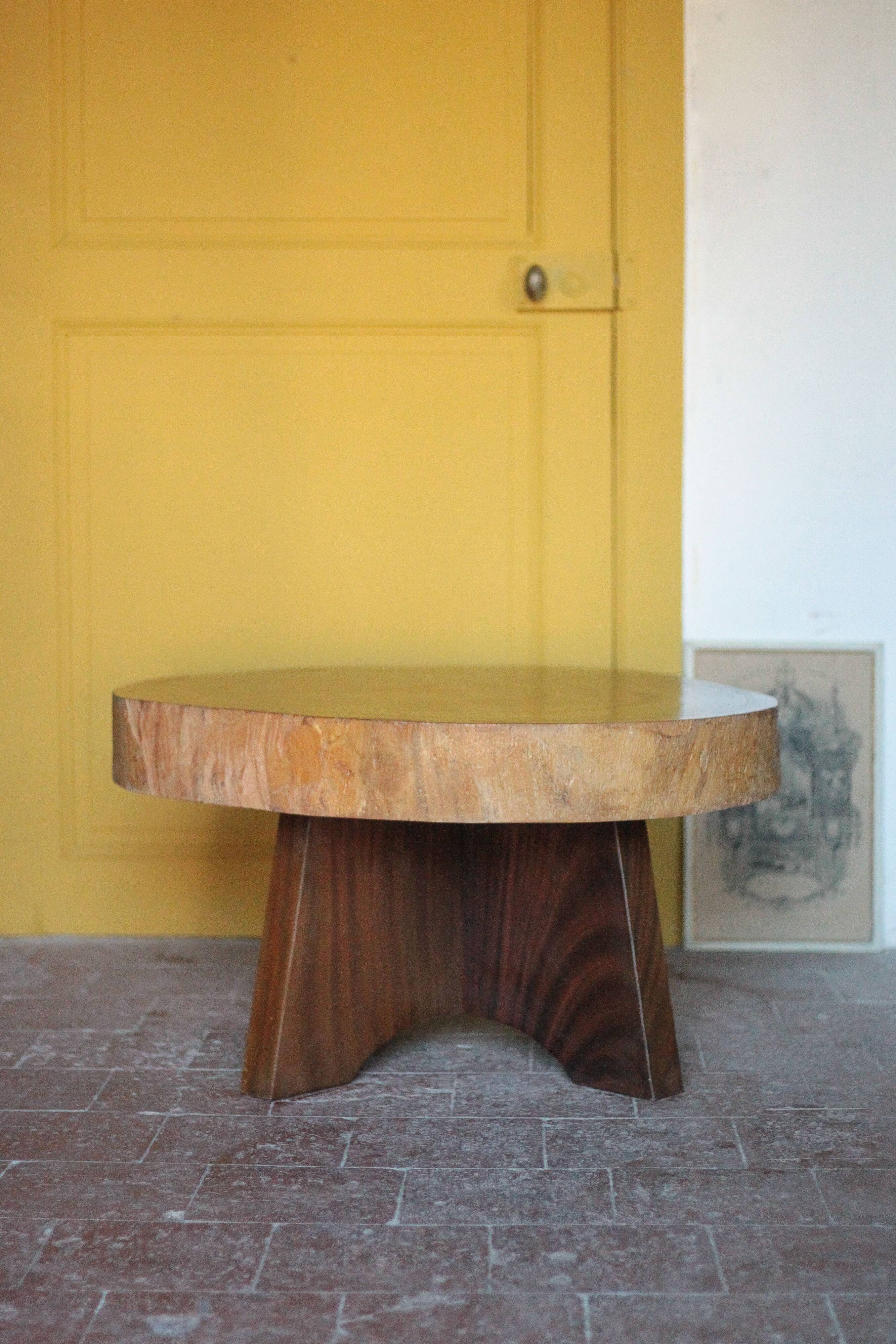 Brutalist wooden coffee table, cruciform leg with a tree trunk top.