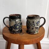 Vintage terracotta mugs with glazed designs and flower/fish motifs