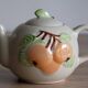 Slush teapot with embossed fruit decoration