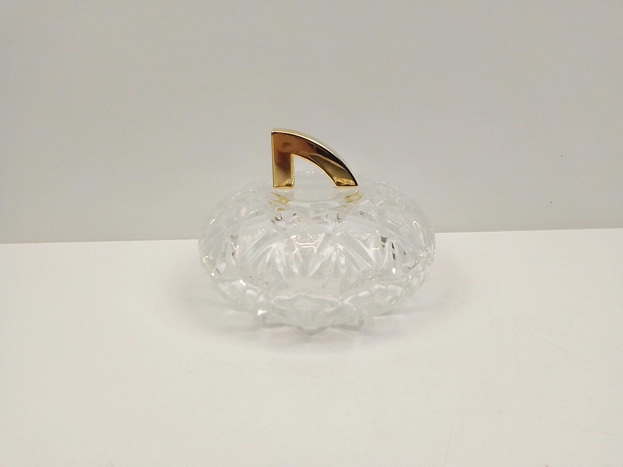 Round crystal box and a golden metal handle