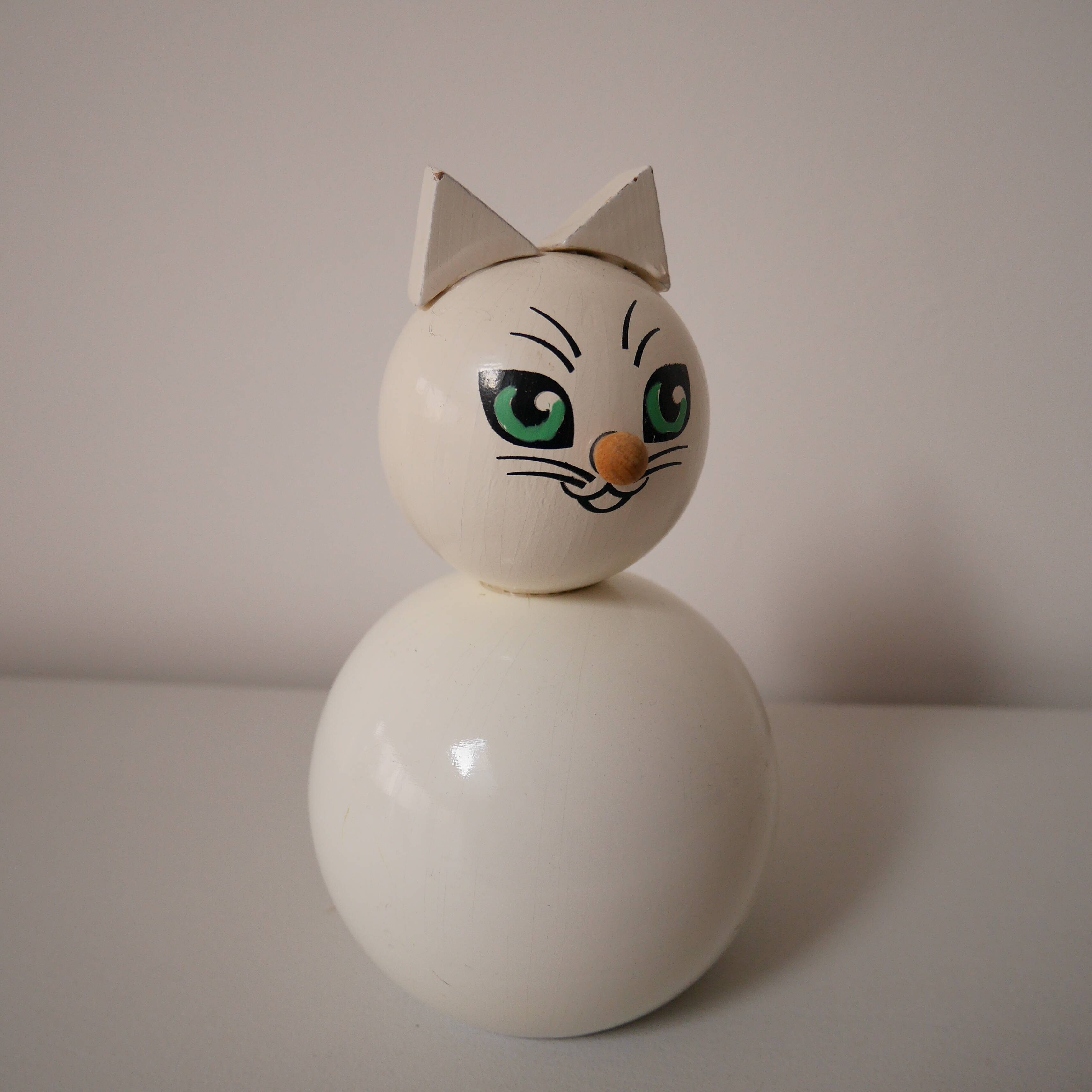 Wooden piggy bank, white cat