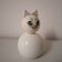 Wooden piggy bank, white cat
