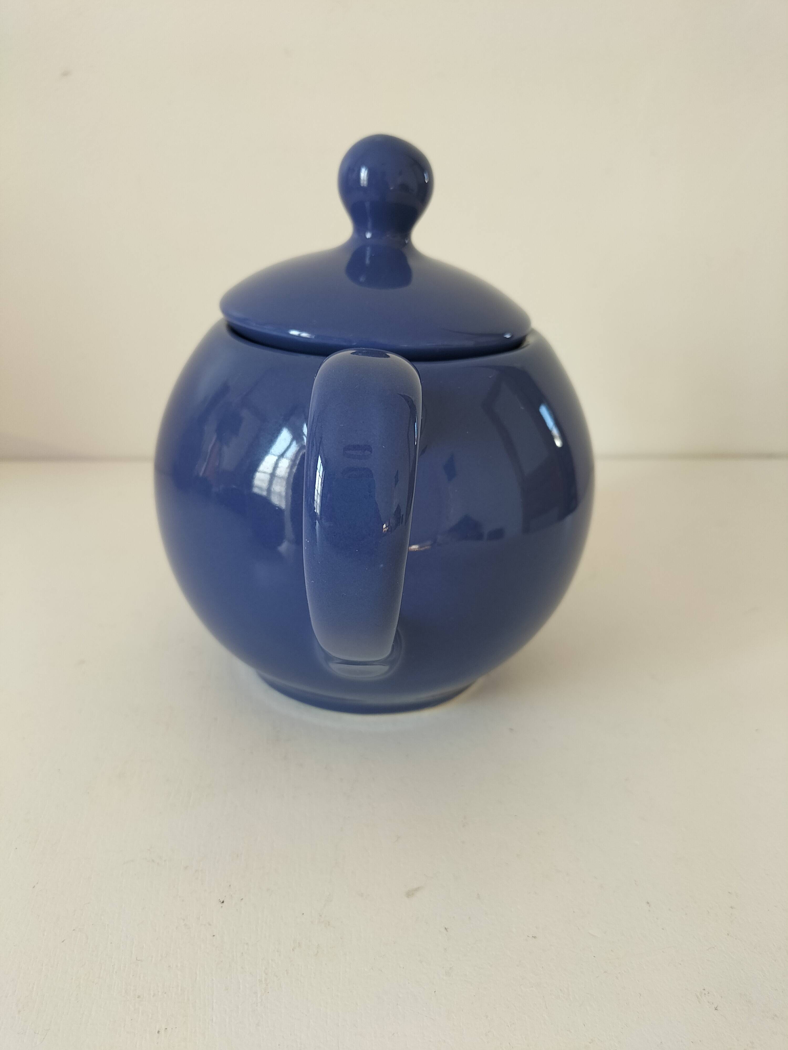 Vintage deep blue teapot, minimalist round shape.