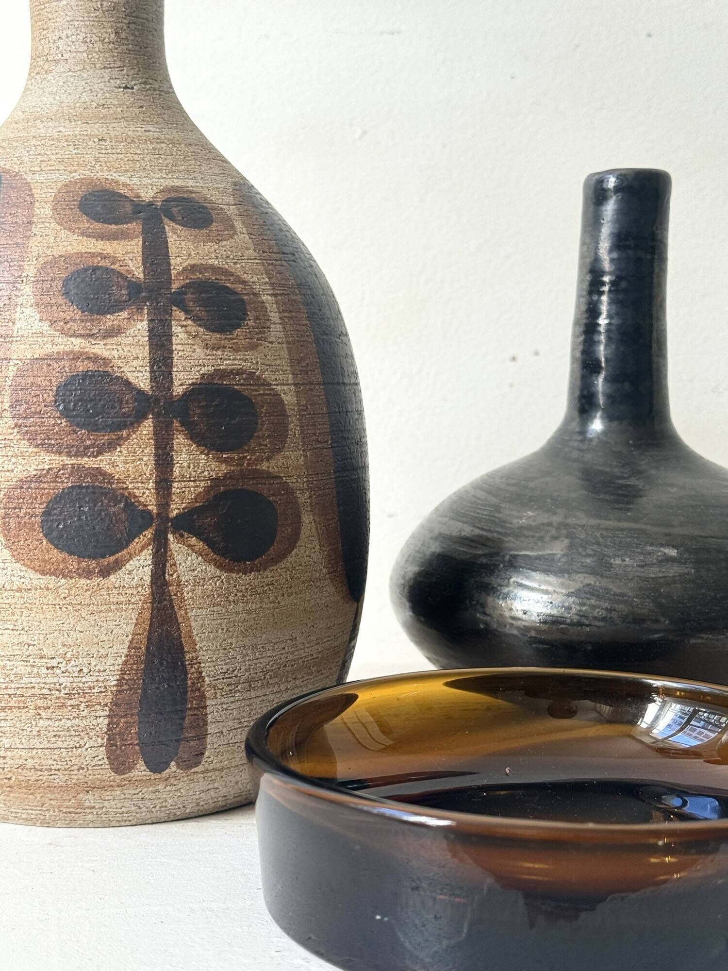 Glazed black ceramic vase with a single stem, signed, circa 1950.