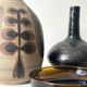 Glazed black ceramic vase with a single stem, signed, circa 1950.