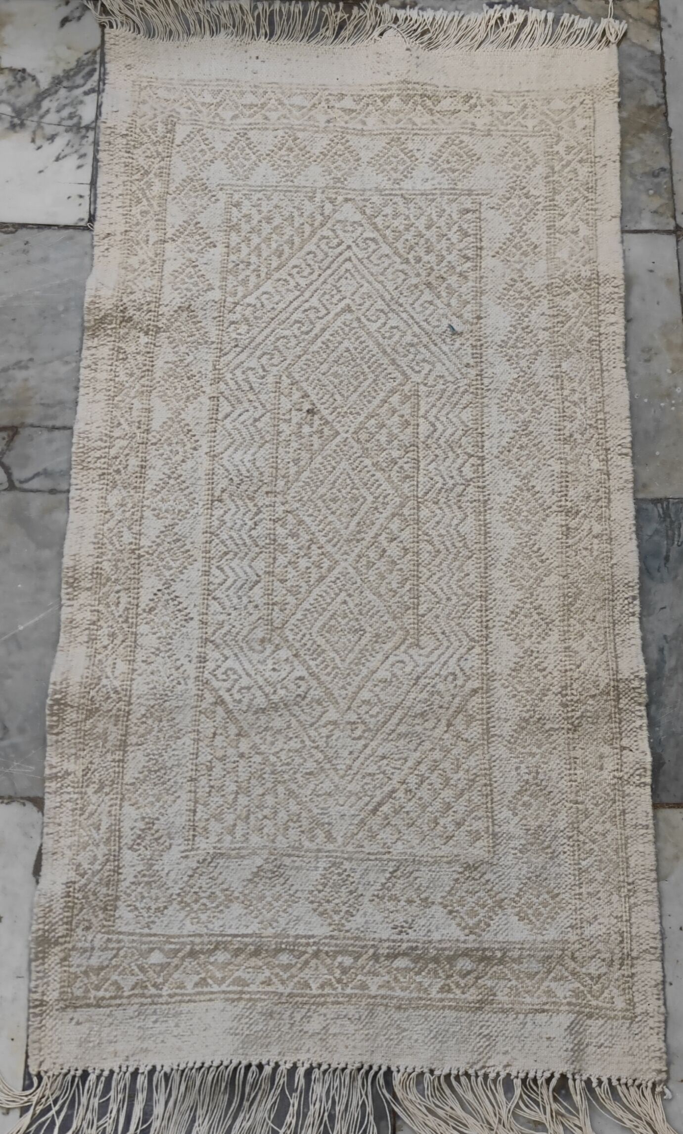 Hand-woven rug in natural wool