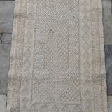 Hand-woven rug in natural wool