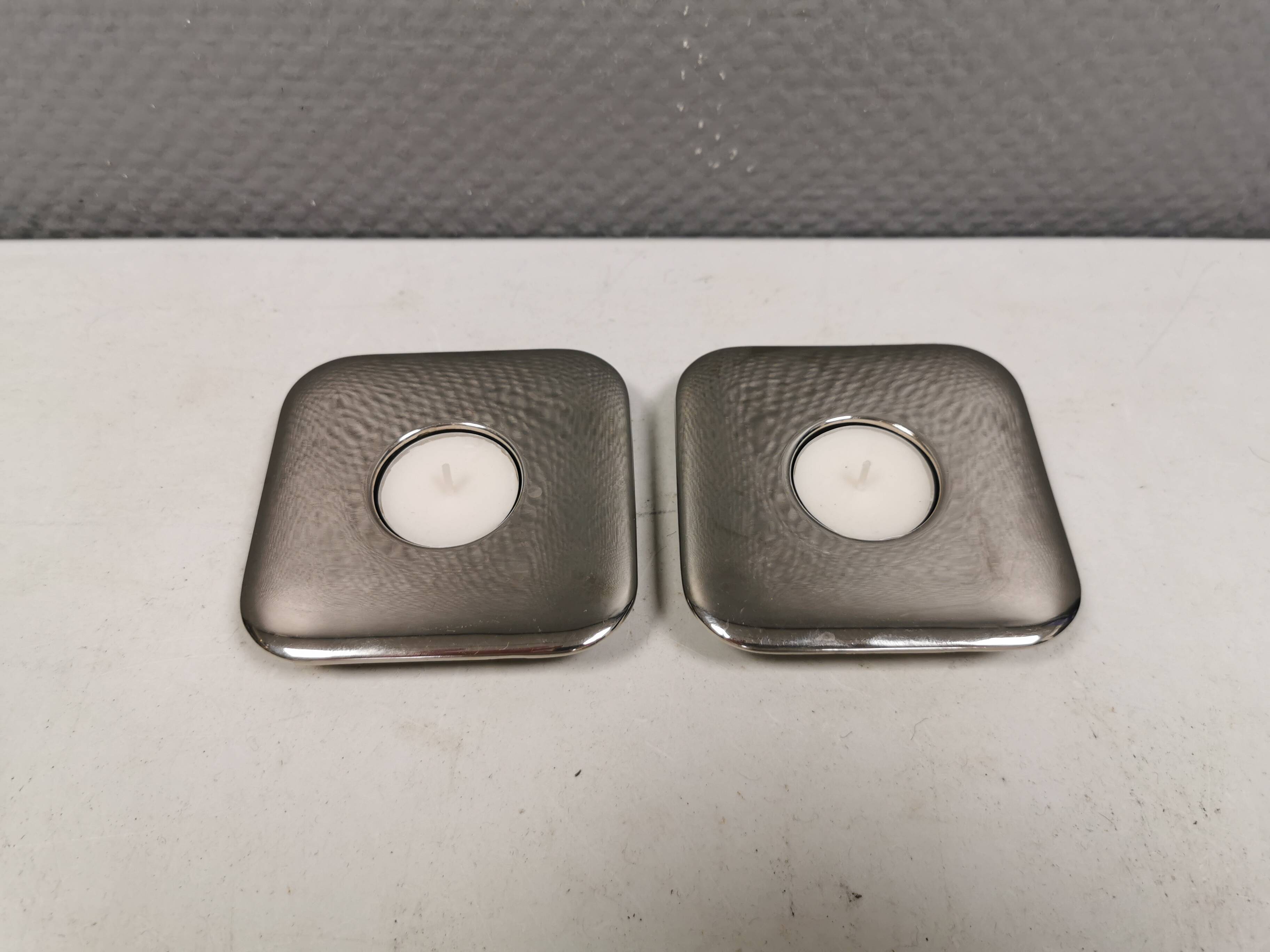 A set of classic Danish candlesticks in polished metal.