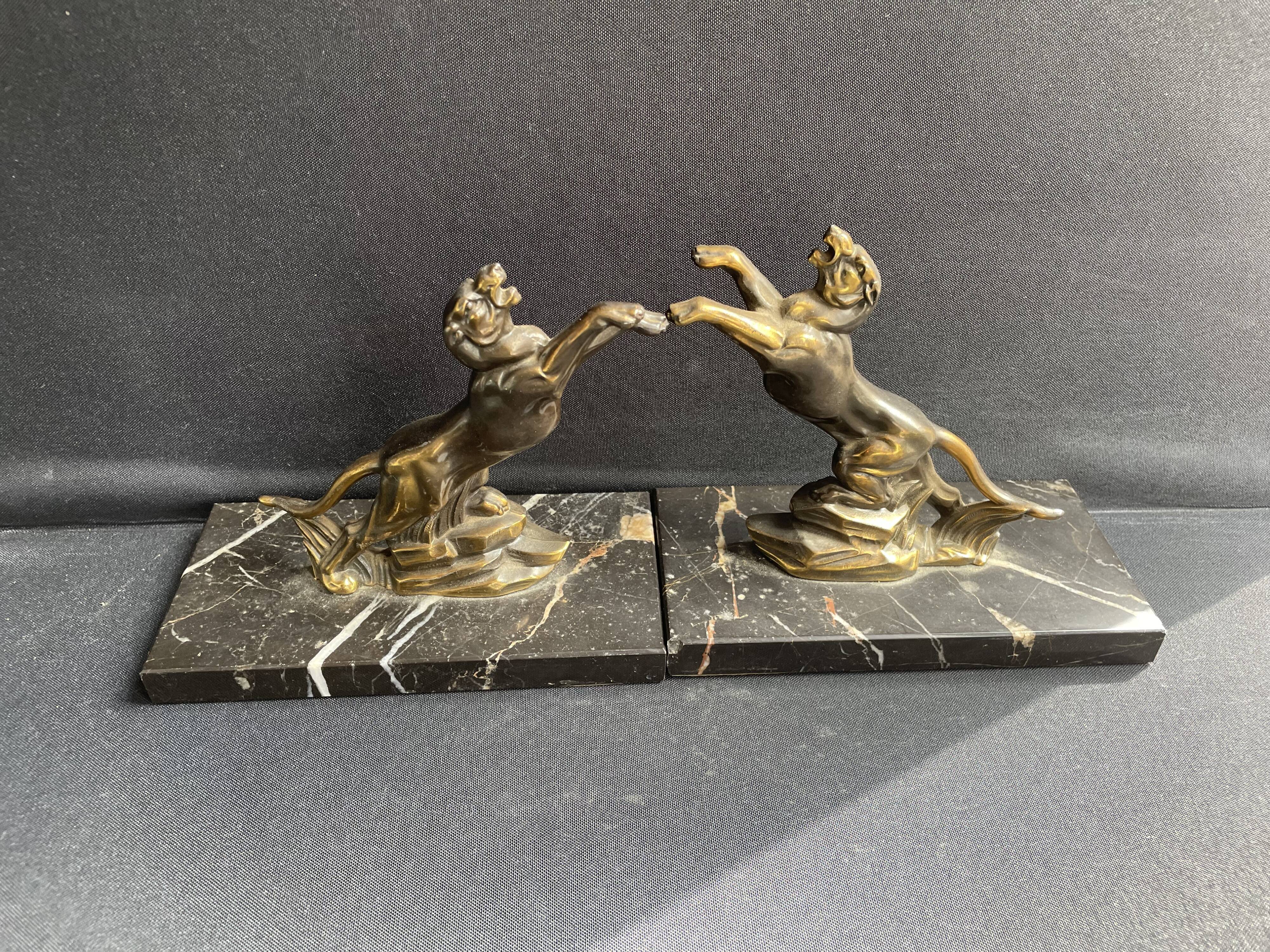 Pair of art deco marble and patinated regulated bookends