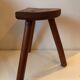 Old wooden tripod stool